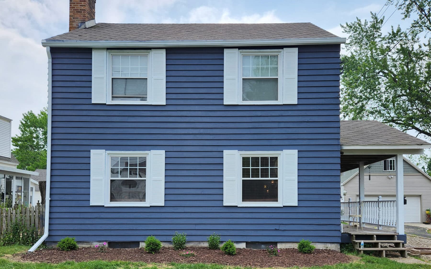 Same colonial home repainted in navy blue with white trim by Fortoso Painting in Kalamazoo, Michigan