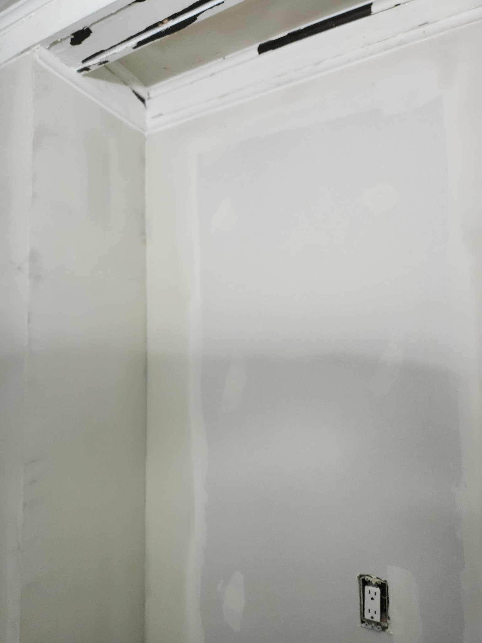 Feathered drywall patches ready for primer during interior prep by Fortoso Painting in Southwest Michigan