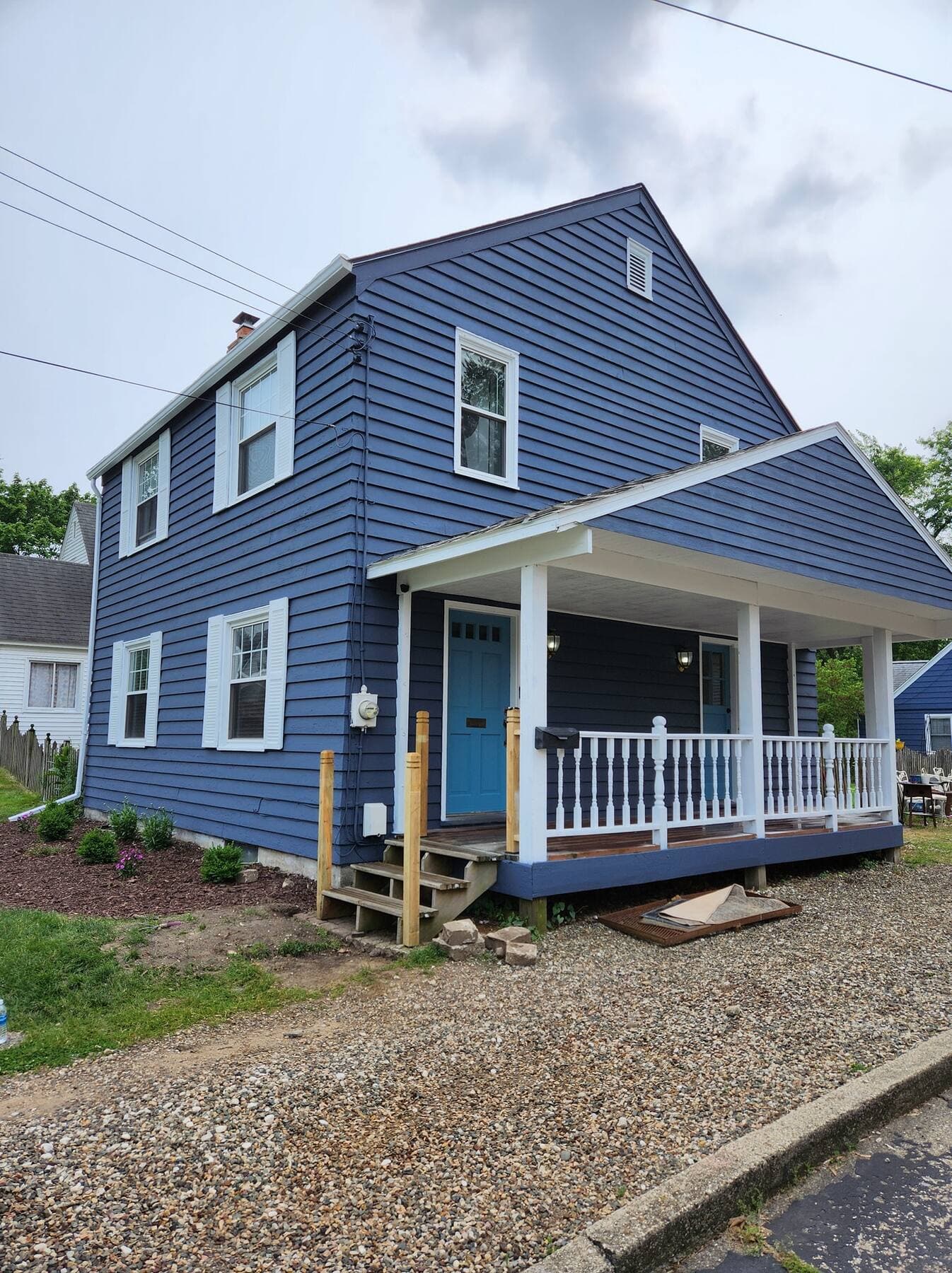 Exterior house painting in Portage, Michigan, navy blue Cape Cod with white trim painted by Fortoso Painting