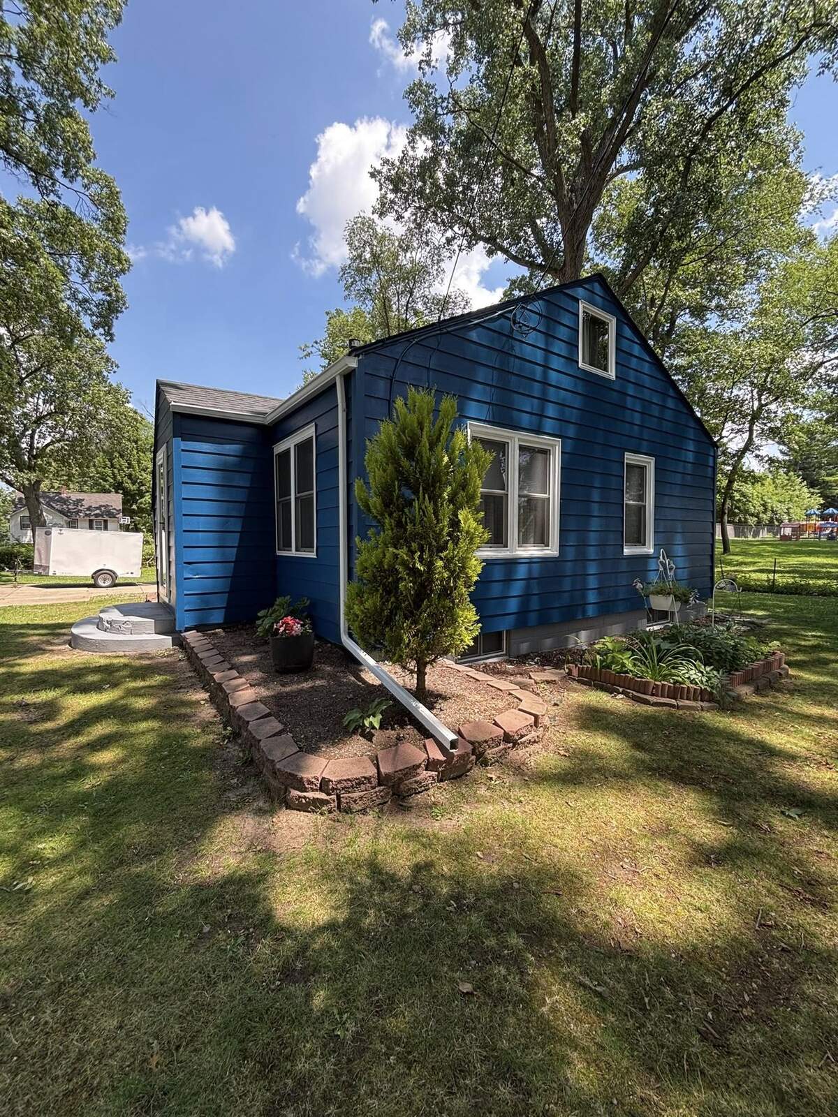 Cottage home painted royal blue by Fortoso Painting in Three Rivers, Michigan