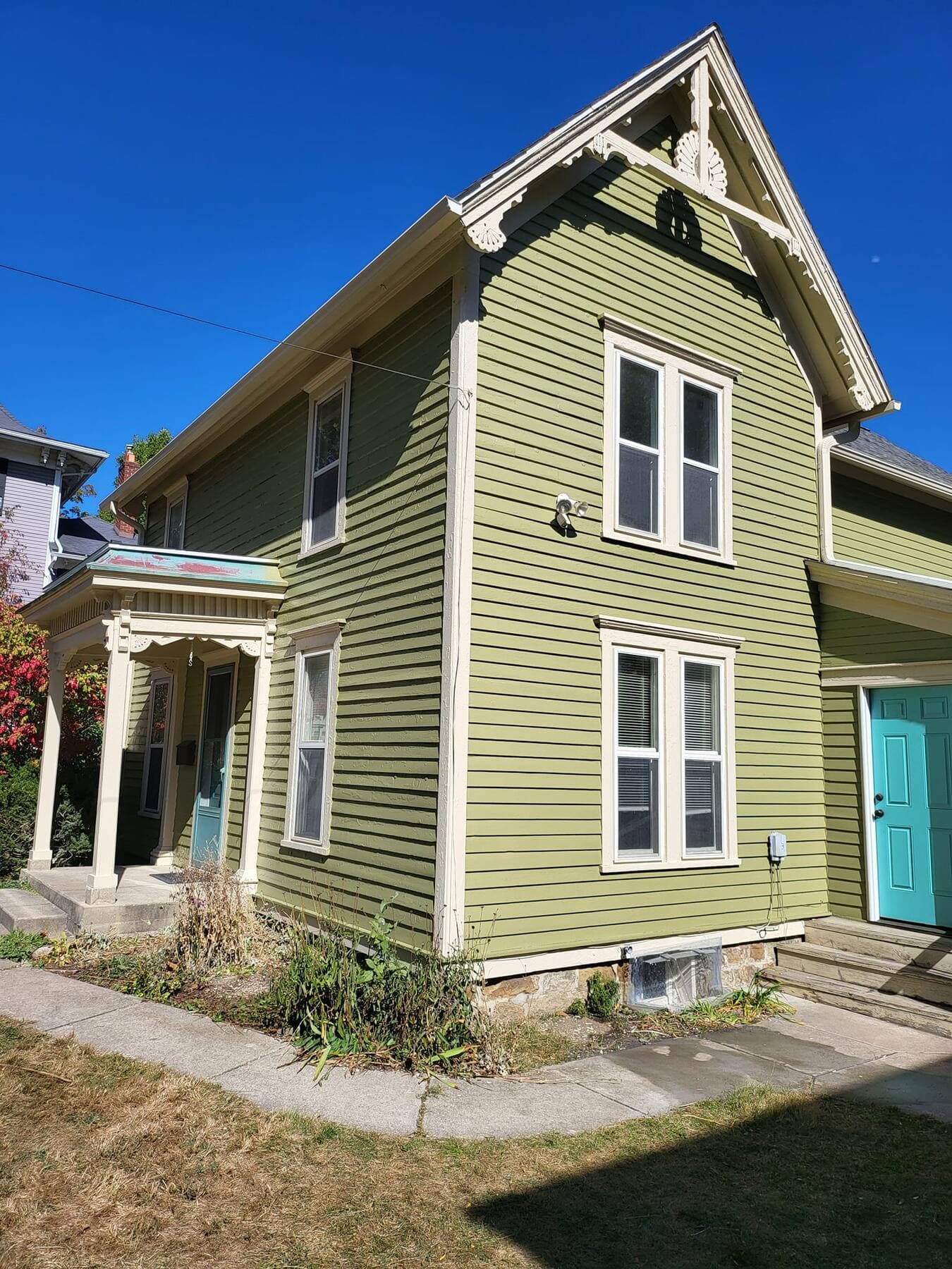 Olive green Victorian home with teal door painted by Fortoso Painting in Kalamazoo, Michigan